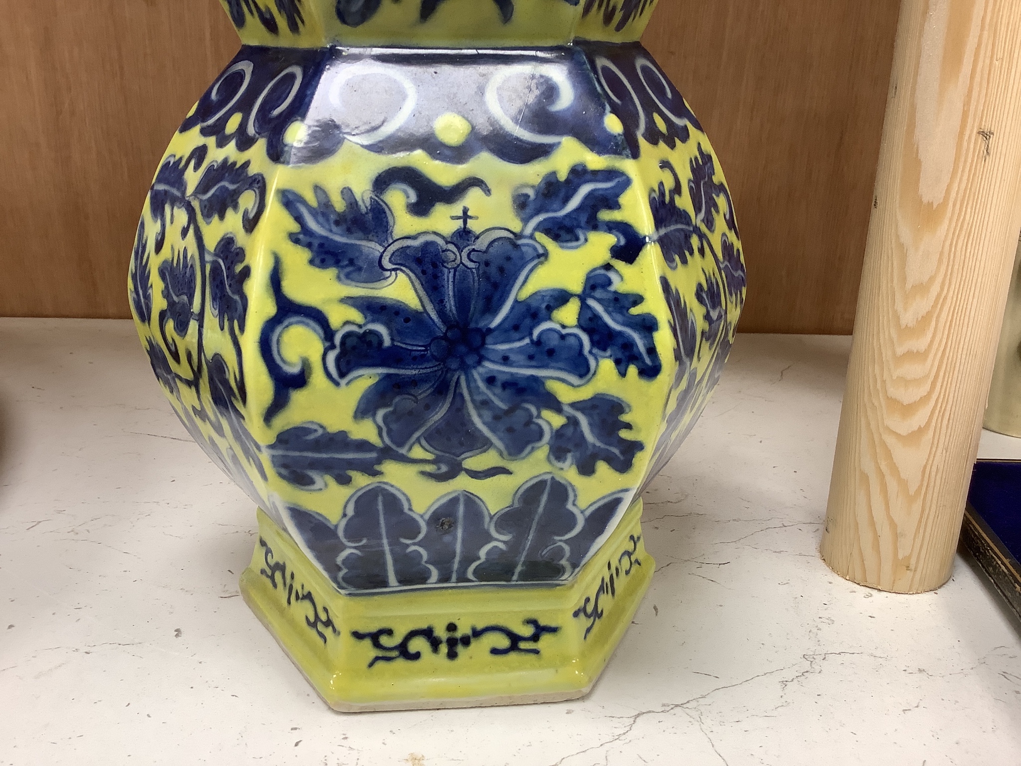 A Chinese underglaze blue yellow ground hexagonal vase, early 20th century, some restoration 35cm